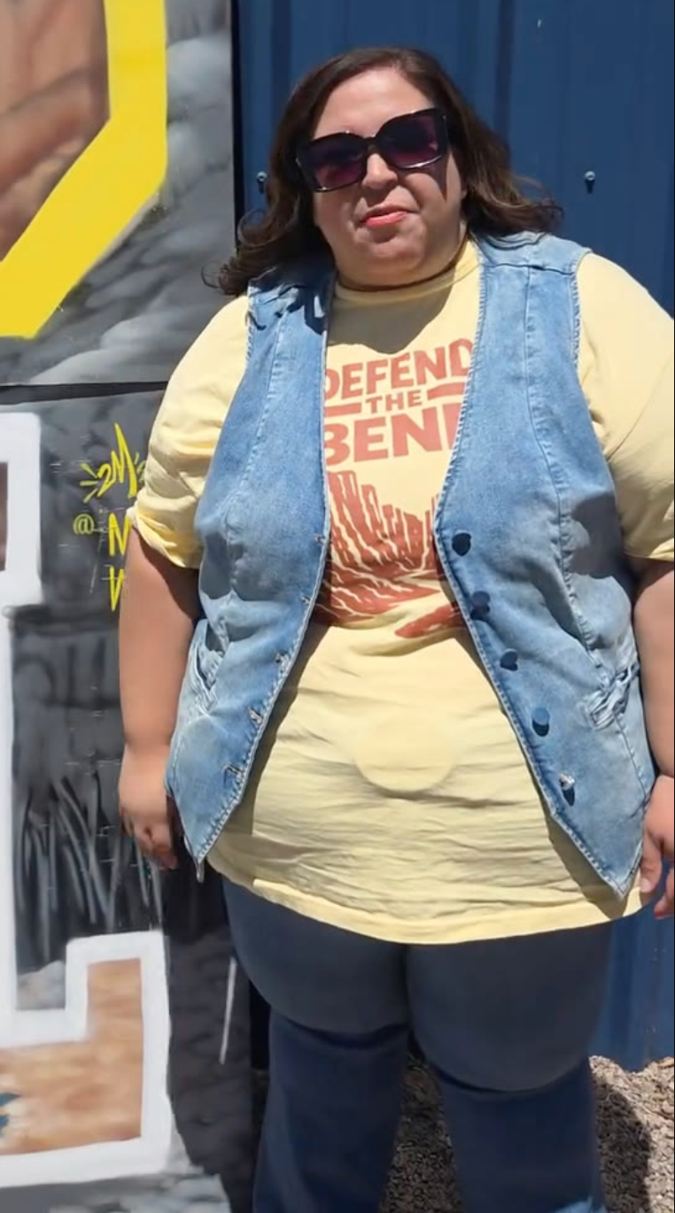 Katy Stout wearing sunglasses and a Defend the Bend shirt at an outdoor campaign stop