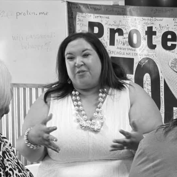 Katy Stout speaking and gesturing at a campaign event