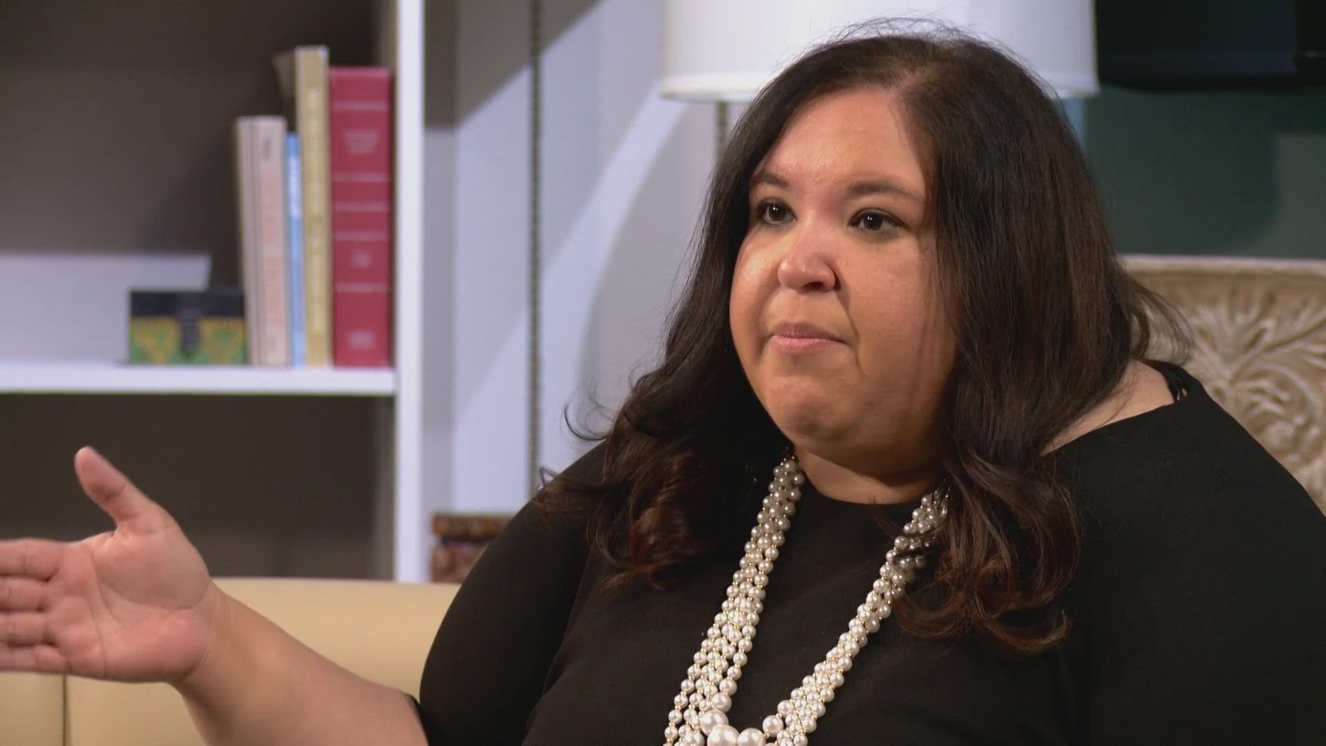 Katy Stout shrugging during a televised interview